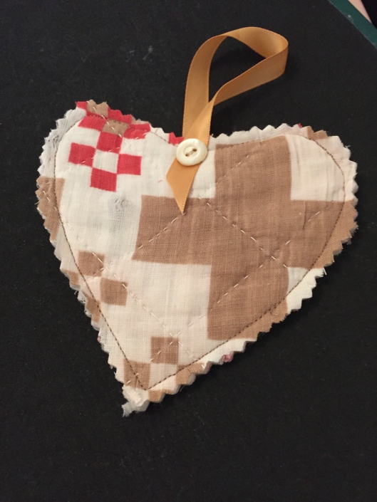 A heart shape cut from the Darting Birds quilt .